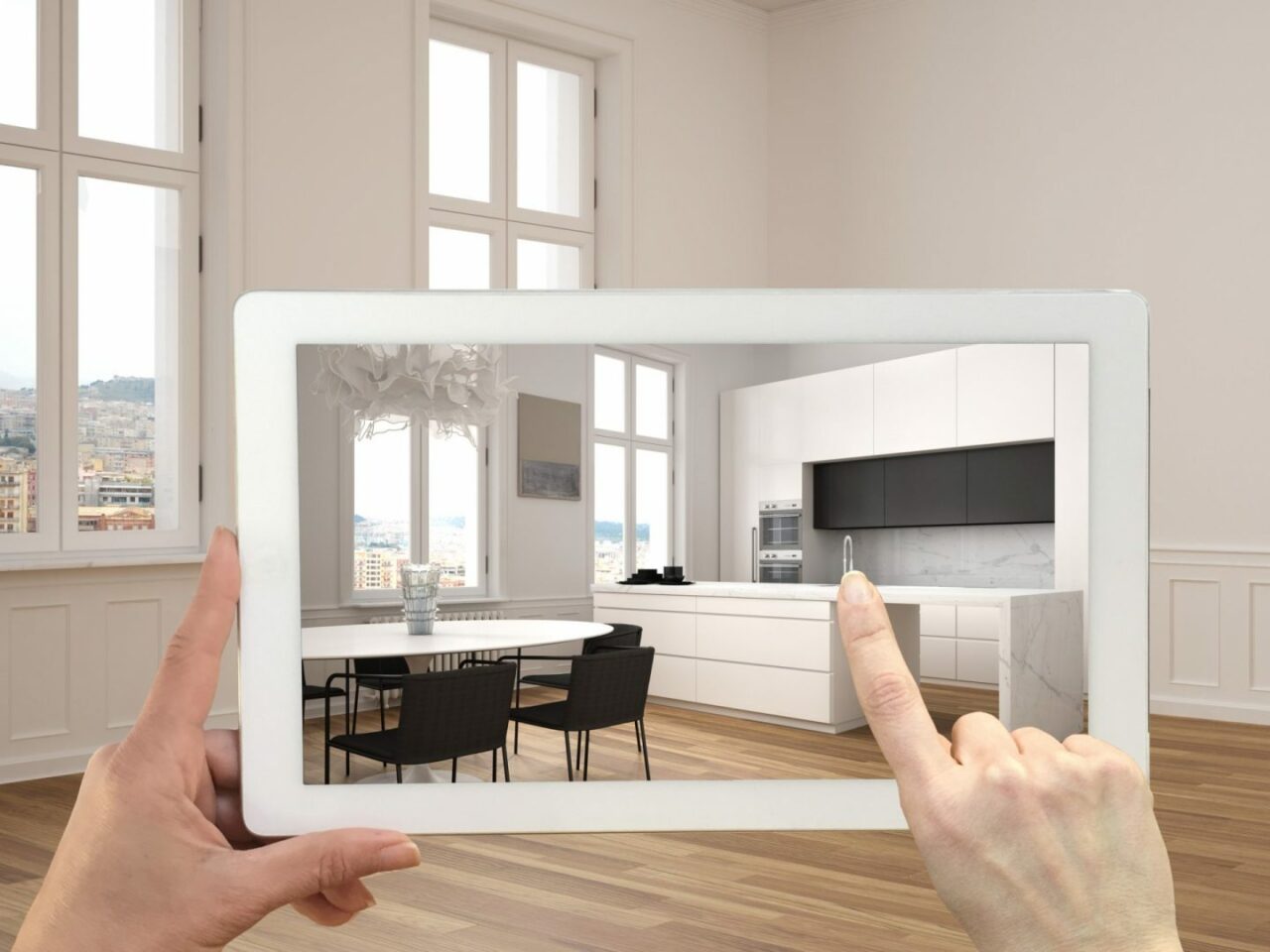 Konzept der Augmented Reality. Eine Hand hält ein Tablet mit einer AR-Anwendung, um Möbel und Designprodukte in einem leeren Interieur mit Parkettboden und einer weißen Küche mit Esstisch zu simulieren.